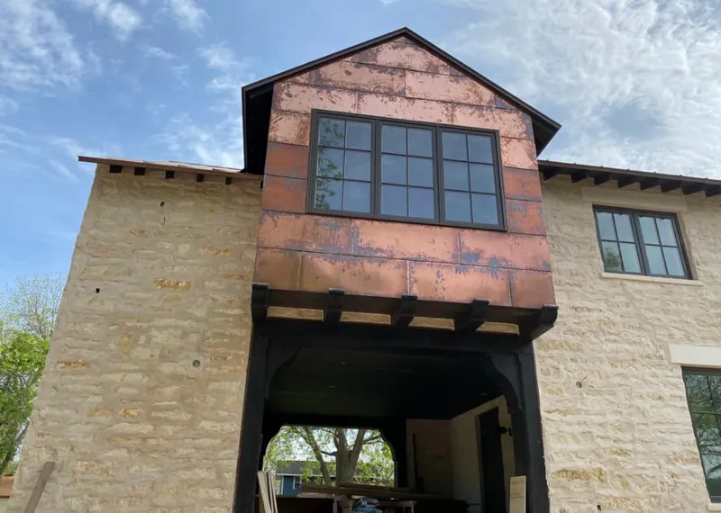 Copper metal panel facade on a stone building for Metal Roof Coating in Anoka
